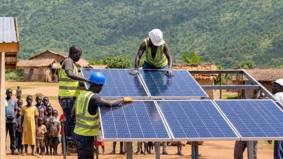 Technicians fitting a solar panel to a village micro-grid array